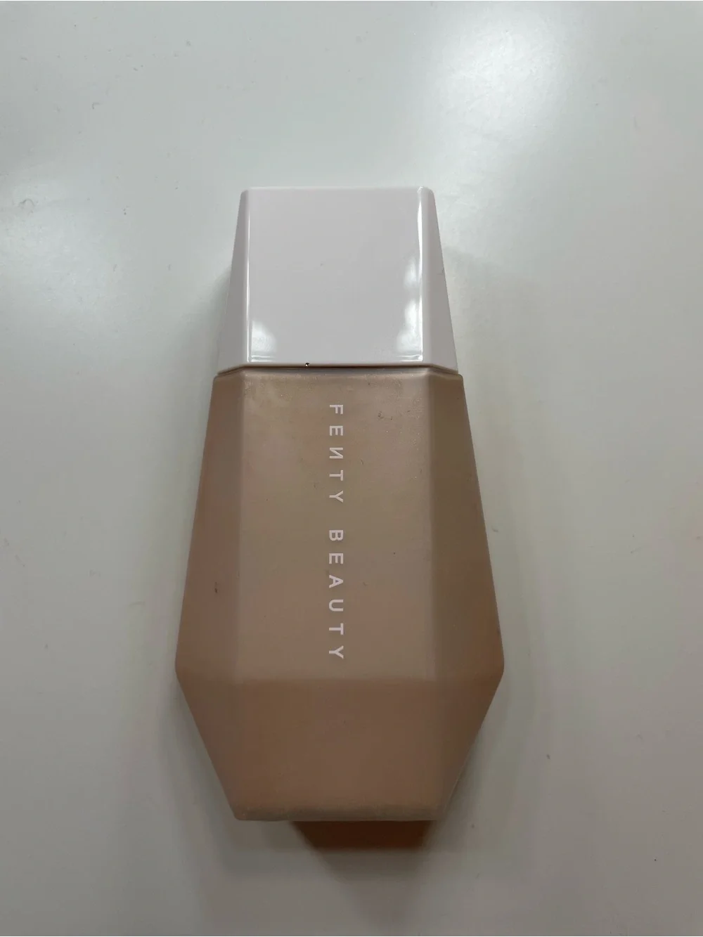 Fenty Beauty Foundation Bottle in Beige with White Cap